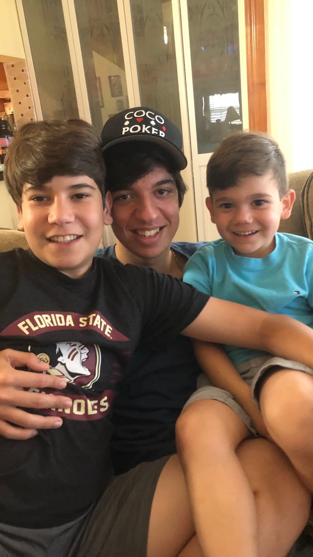 Ryan in a pink bucket hat with his brother