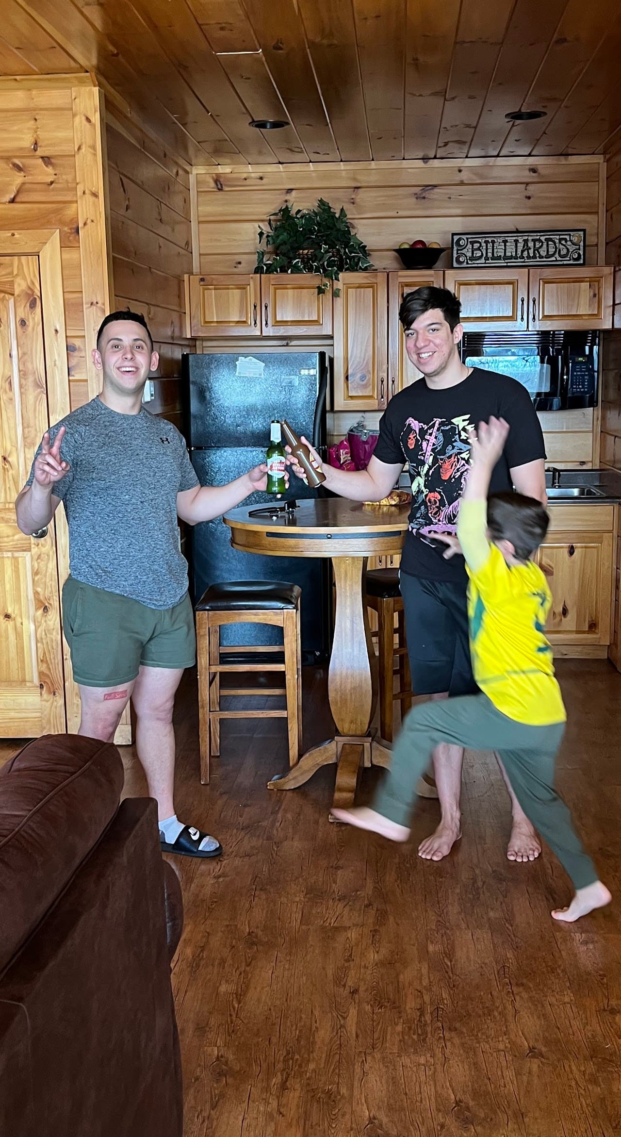 Ryan with his brothers at the trampoline park in colorful socks